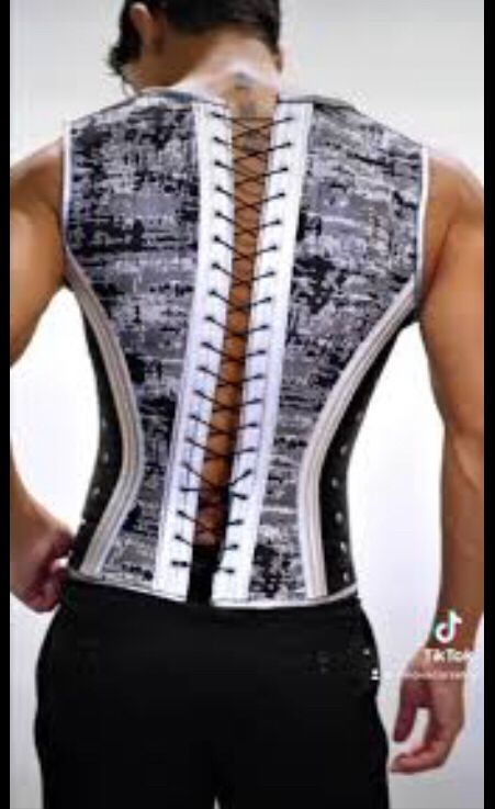 The back of a man wearing a corset. 
