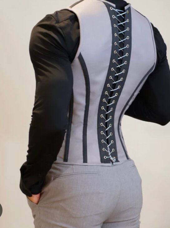 The back side of a man wearing a corset. His butt looks amazing. 