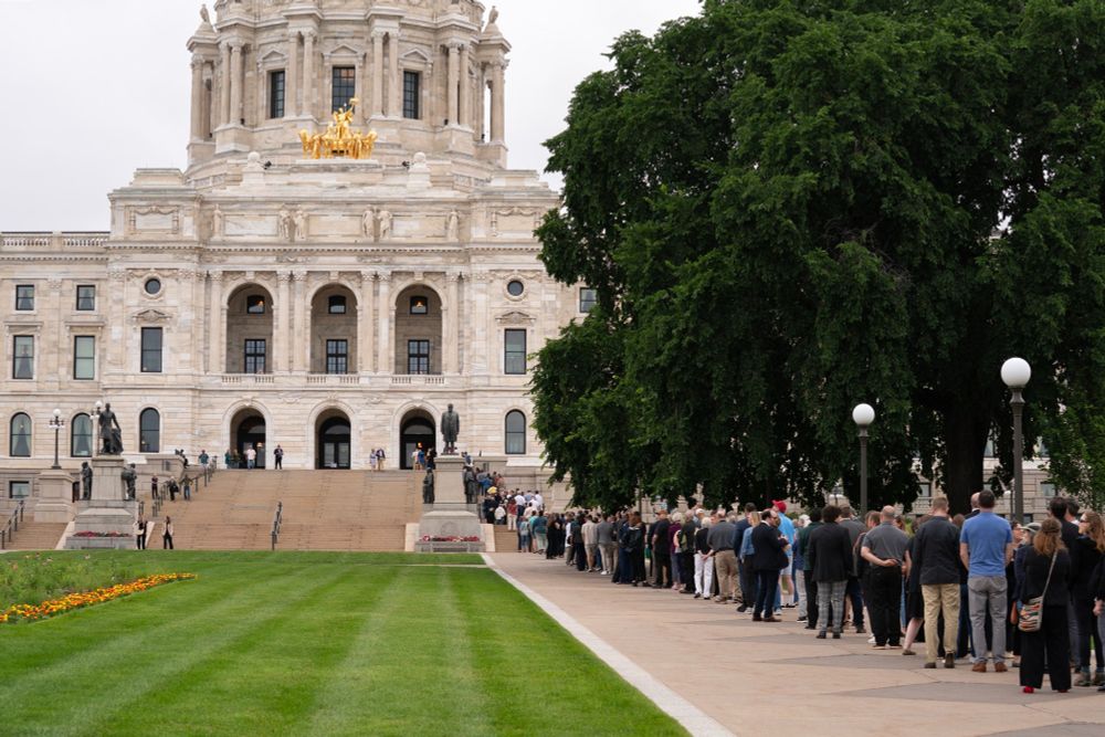 The Minnesota State Capitol Mall with a line of people waiting to pay respect to the Hortmans. 