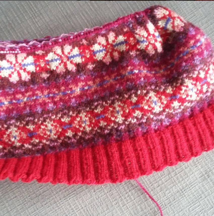 Start of a red/purple fair isle sweater