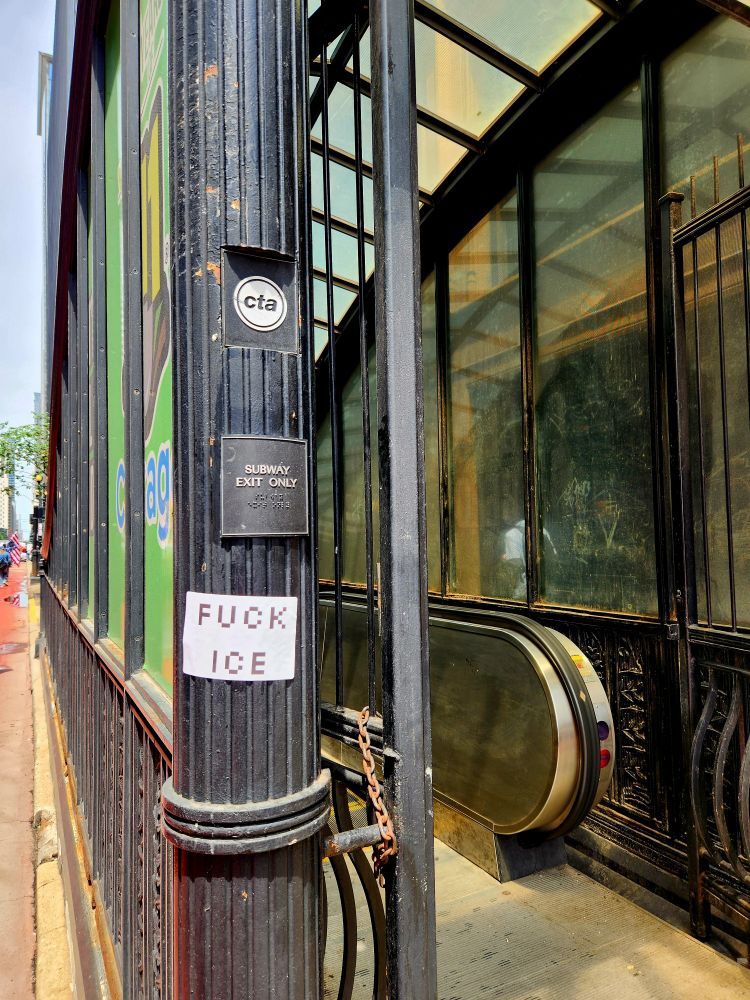 A sign at a Chicago Transit Authority entry way to the trains reads "FUCK ICE"