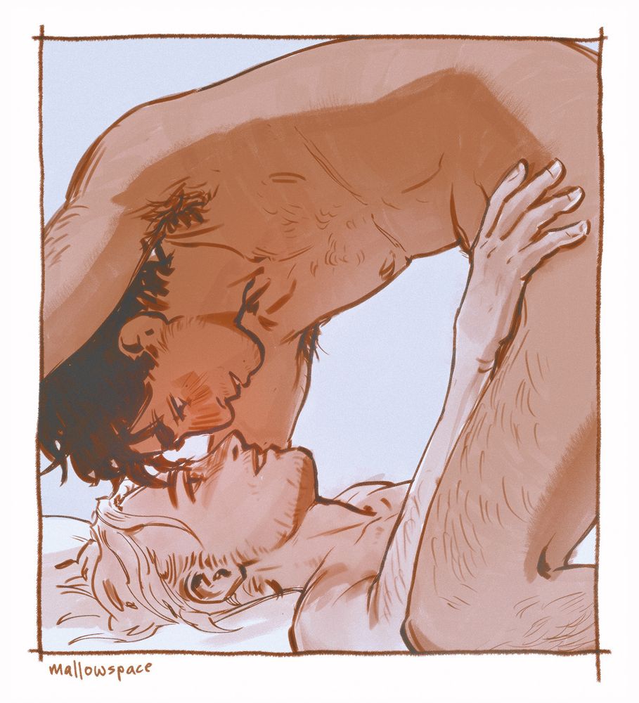 two men in bed together. one is positioned over the other, smiling at each other, foreheads almost touching