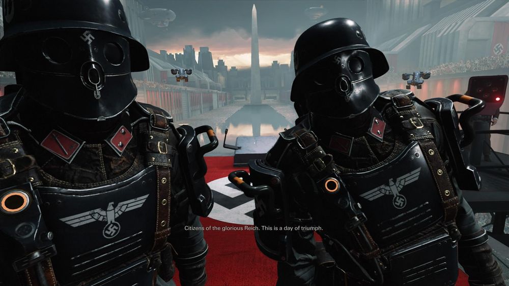 Screenshot from video game Wolfenstein II with two masked and heavily armoured stormtroopers in front of the Lincoln Memorial with the subtitle: “citizens of the glorious reich. This is a day of triumph”.