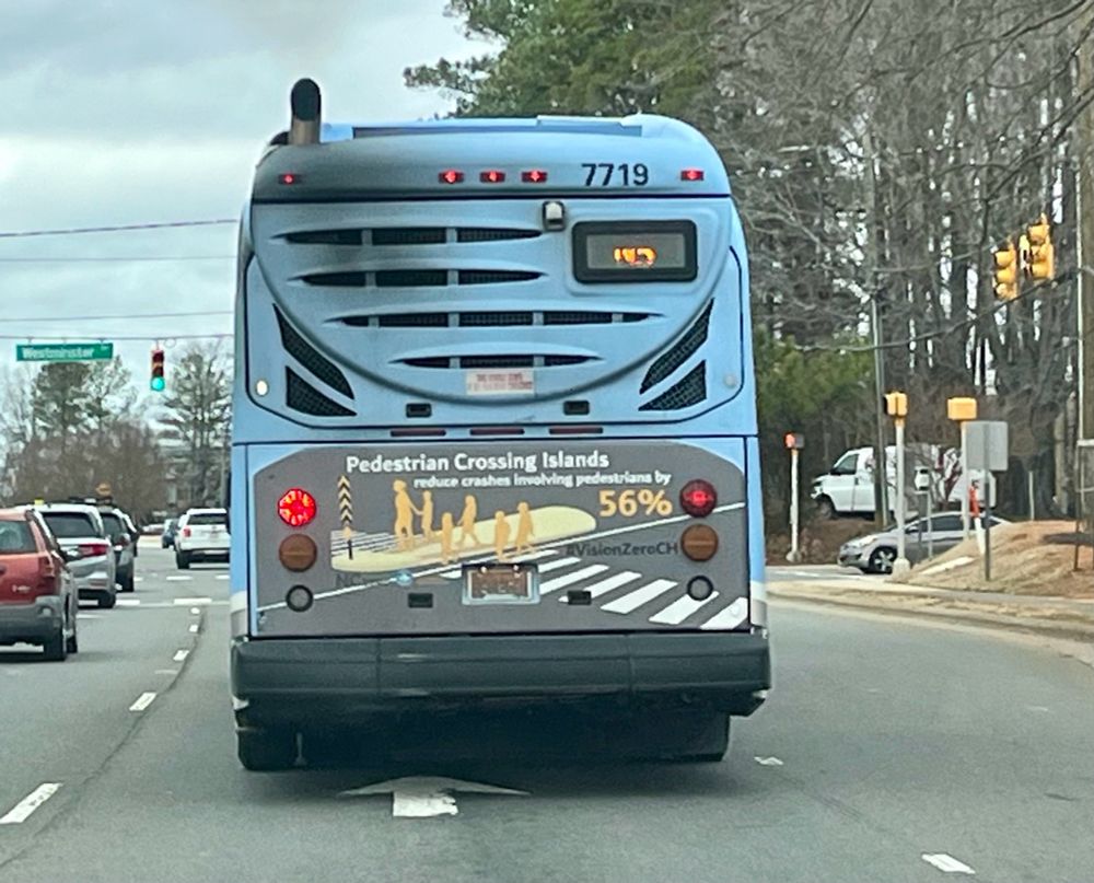 Chapel Hill Transit bus with as that reads: pedestrian crossing islands reduce crashes involving pedestrians by 56%