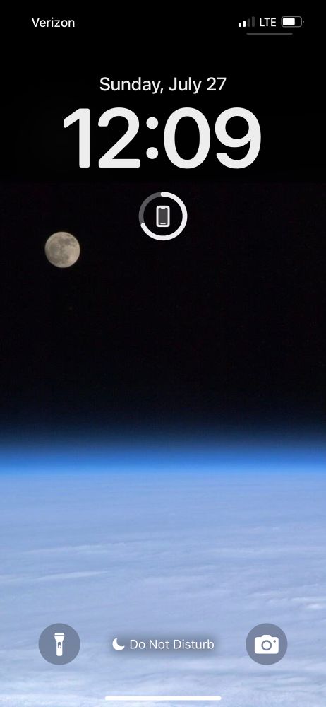 Phone Lock Screen featuring a space view of earth with moon in background 