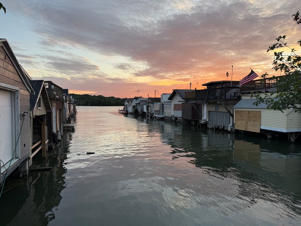 Canandaiga lake pier at sunset.  It has lots of little boat sheds 