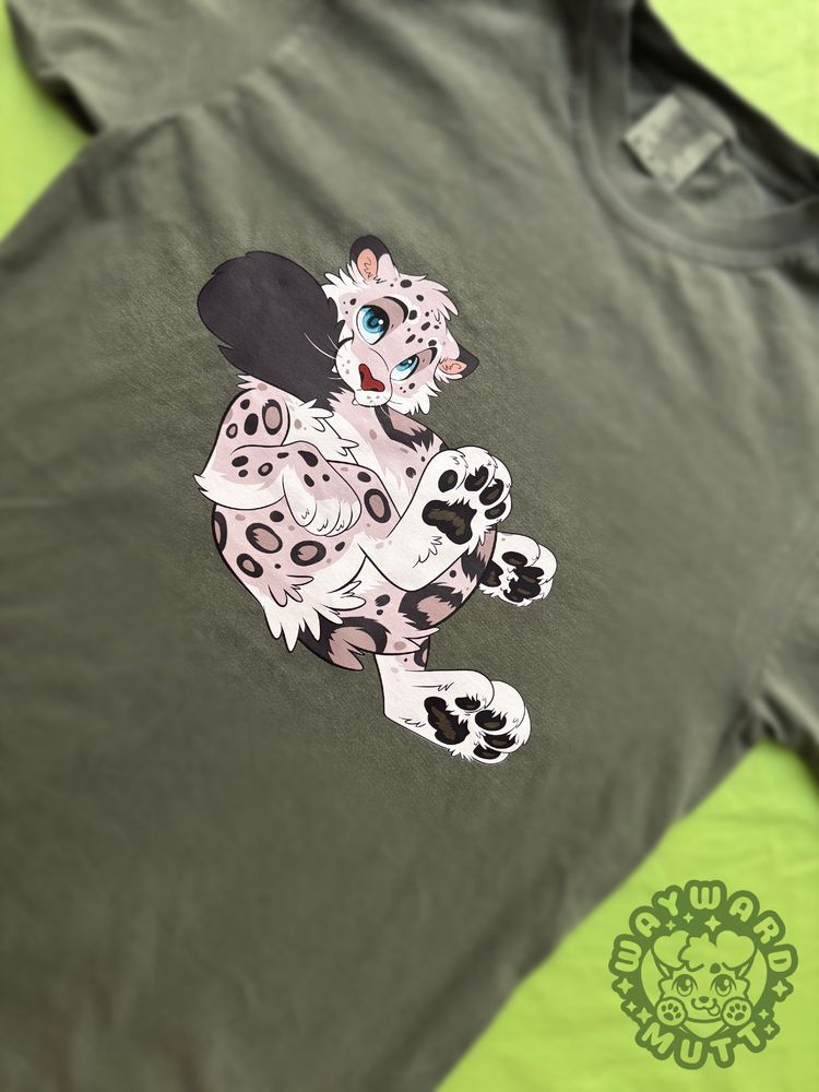 a green tshirt with a snow leopard grabbing its tail