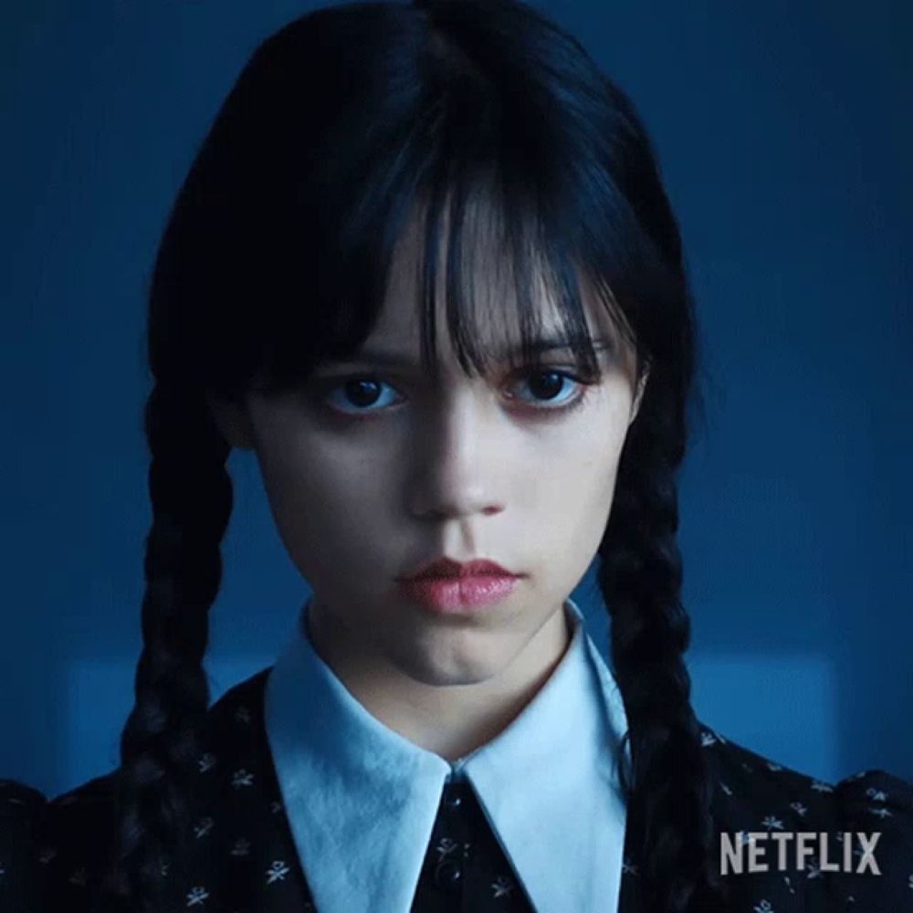 a girl with braids and a netflix logo on her shirt