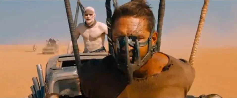 Mad Max Fury Road: Max strapped to the front of a car making this face 😐”