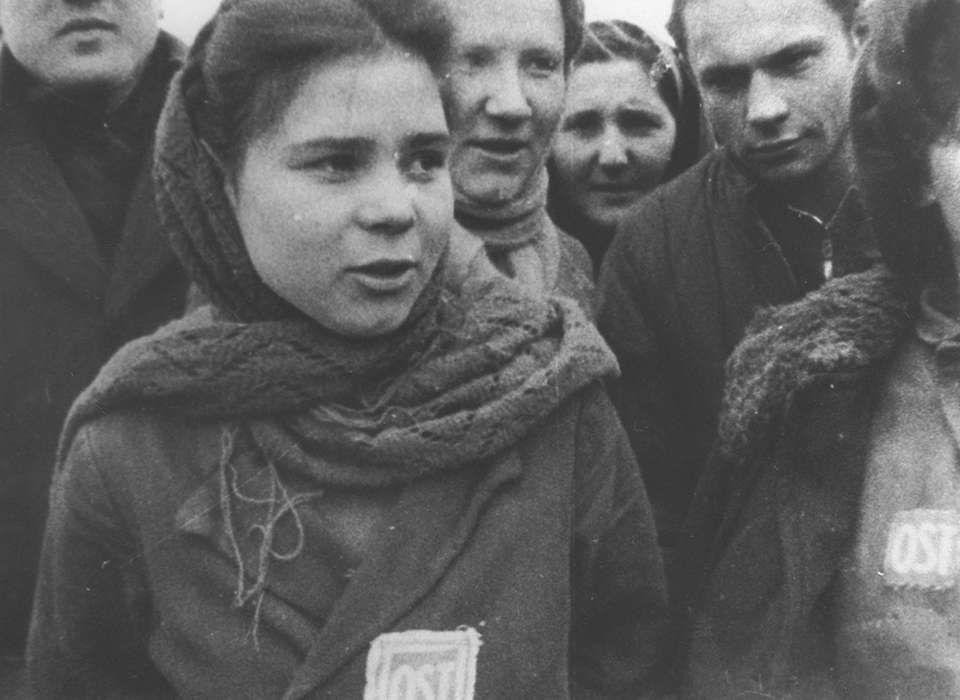 forced laborers wearing “OST” (Ostarbeiter) badges are liberated from a camp near Łódź, January 1945, Łódź Poland, United States Holocaust Memorial Museum, courtesy of an unknown Russian archive, 19317. 