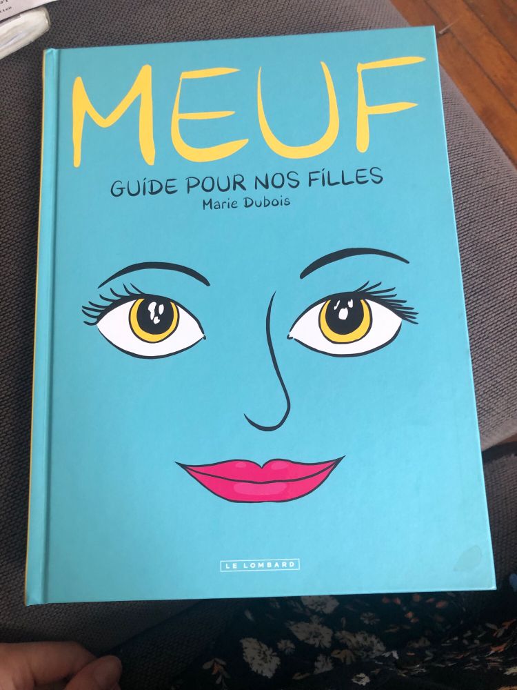 Première de couverture de la BD Meuf de Marie Dubois (éditions Le Lombard). On y voit un visage féminin souriant sur un fond bleu turquoise.