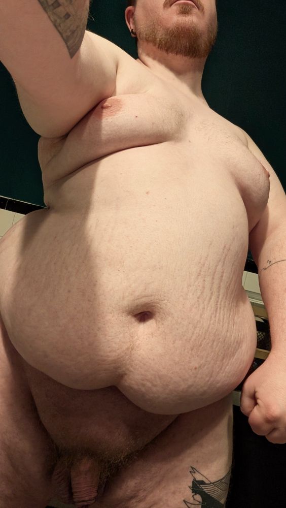 Naked, belly and titties looking plump and juicy, above my bushy and soft uncut cock 