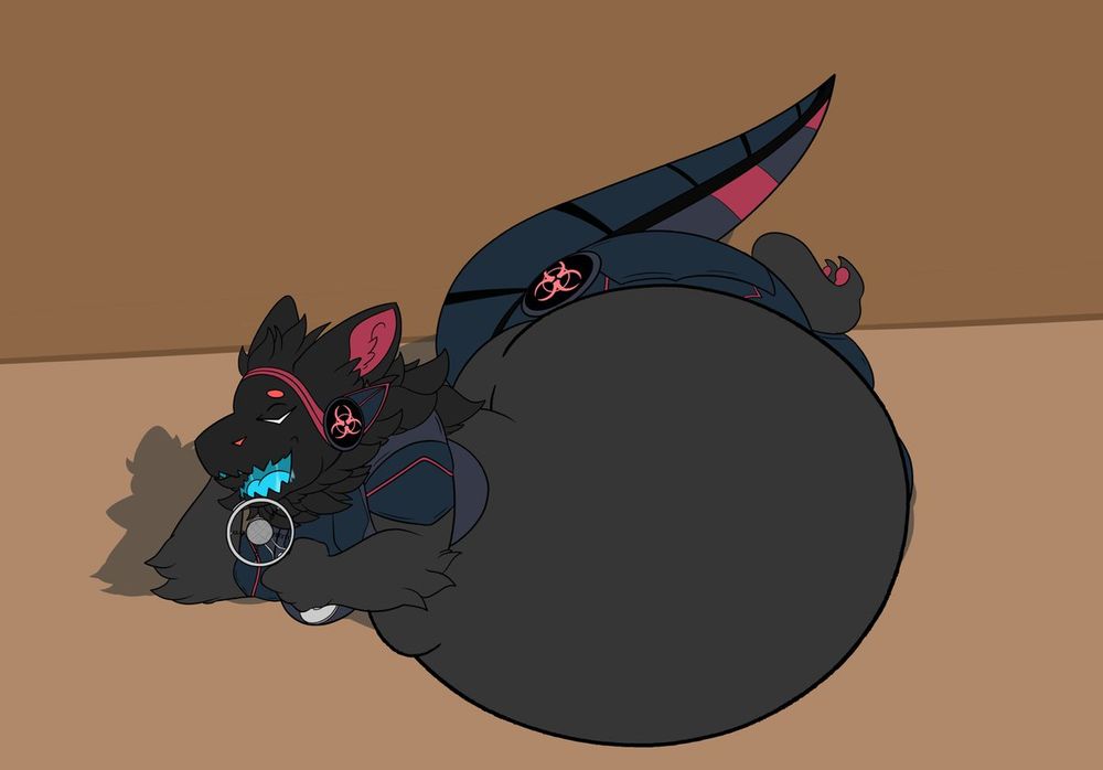 BaSURA lays fat and engorged on his side, speaking into a fancy microphone.