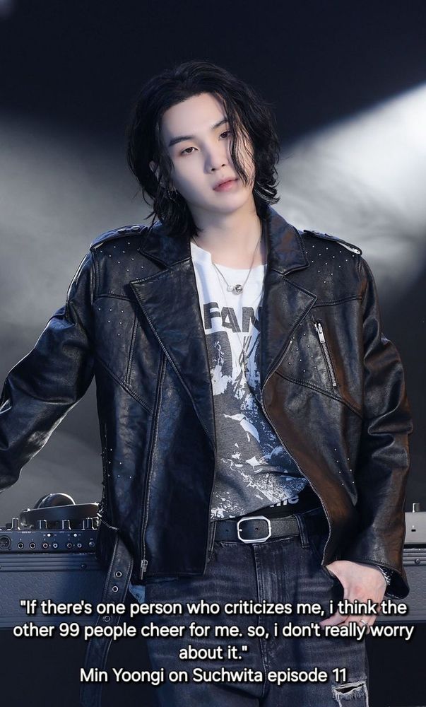 Yoongi with long black hair, dark ripped jeans, and a black leather jacket over white screenprinted tshirt and quote "If there's one person who criticizes me, i think the
other 99 people cheer for me. so, i don't really worry
about it."
Min Yoongi on Suchwita episode 11