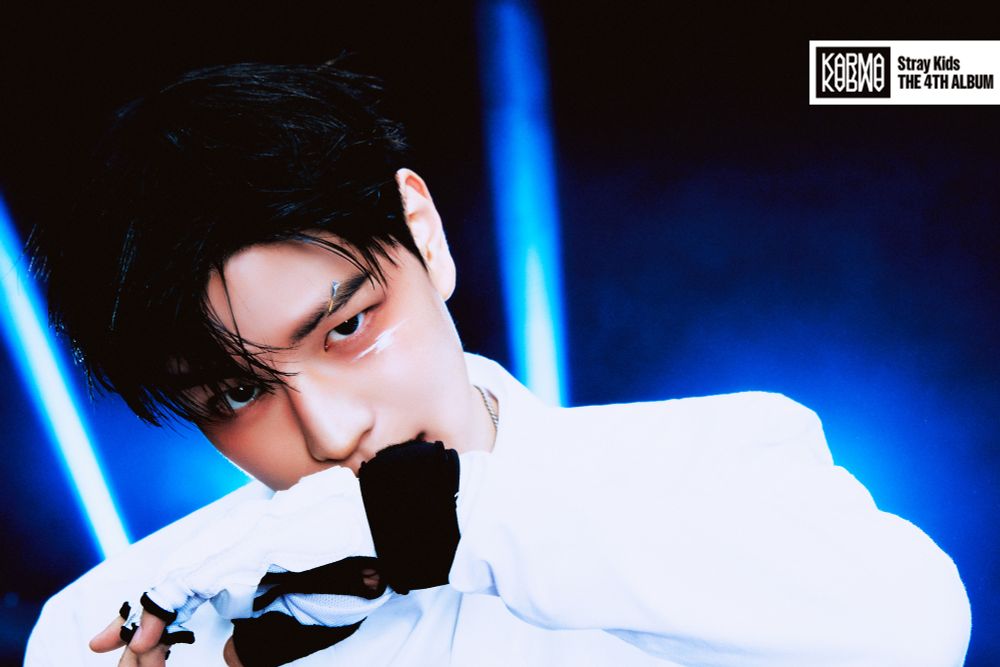 Seungmin for Karma. He's looking at the camera and has his hand up, his wrist covering his mouth. He looks soooo good.