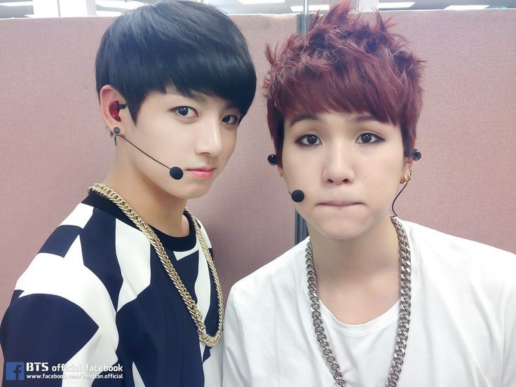 debut era jungkook and yoongi. jungkook with his black bowl cut, and heavy gold chains around his neck. yoongi wearing a large silver chain, and his signature dark red cut