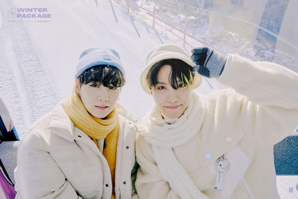 yoongi and hoseok all wrapped up in cosy winter coats and scarves for the bts winter package 2021