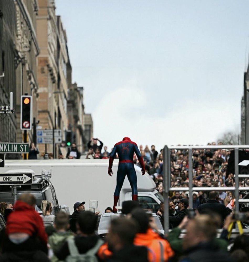 Photo of Spider-man standing on a vehicle over a sea of people during the shoot for Brand New Day