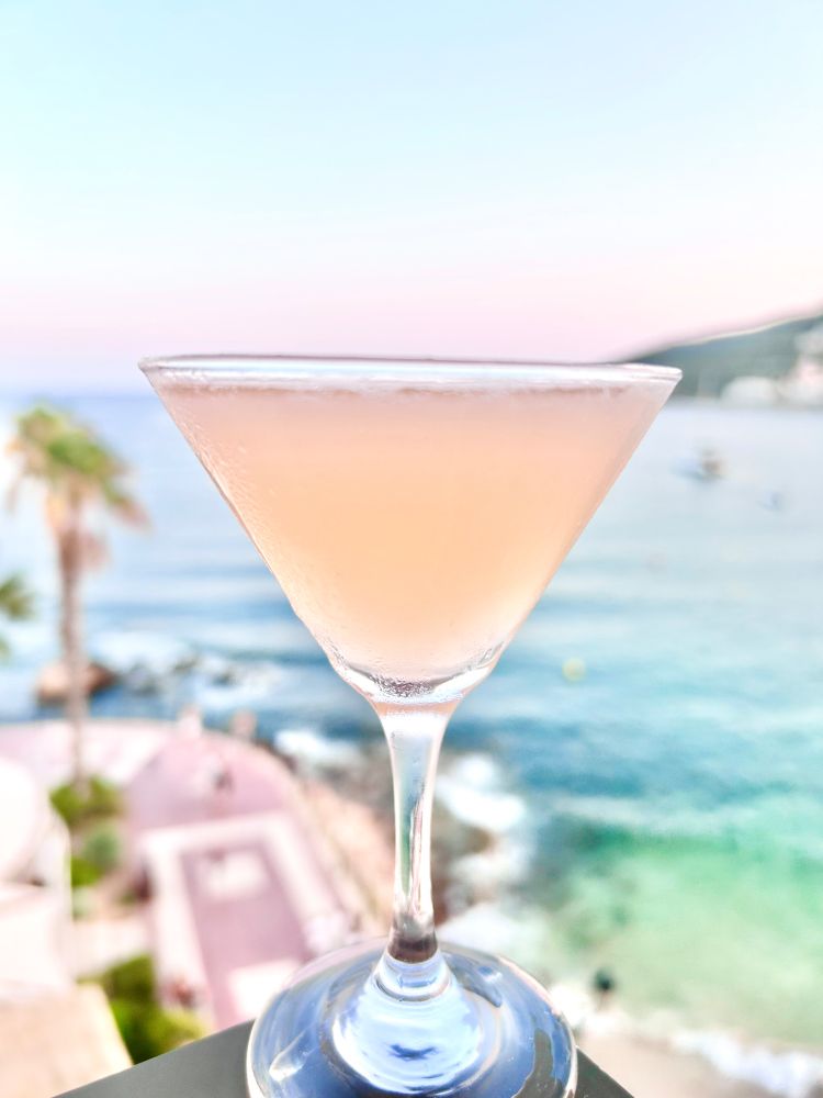 A perfectly peach coloured cocktail in a martini glass set against a background of the mediterranean sea and palm trees.... aint I a stinka?

45ml London dry gin.
15ml Tripel sec
7.5ml fresh lime juice (round up as appropriate)
5ml simple syrup (2-1 sugar water)
1 dash angostura bitters
1 dash orange bitters (both angostura and Regan's are excellent here though the Regans provides a more herbal note thats not unwelcome)

Shake everything over ice and double strain into a glass of your choice. 