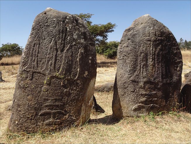 Two standing stones featuring carvings of sword blades or lance-heads and ‘Y’-shapes, erected by Indigenous religious communities at Tiya, Ethiopia.