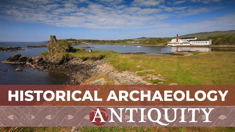 View of Dunyvaig castle and the Lagavulin distillery in Lagavulin Bay on the Scottish island of Islay, with the text 'Historical Archaeology, Antiquity'. 