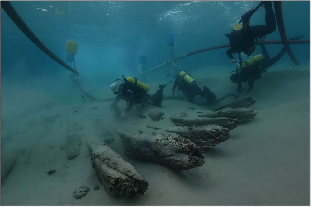 Divers excavating the hull of a shipwreck. 