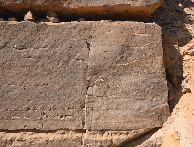 The rock art panel, engraved with a depiction of a boat supporting a human figure on a palanquin-like structure (credit: Dorian Vanhulle, AKAP).