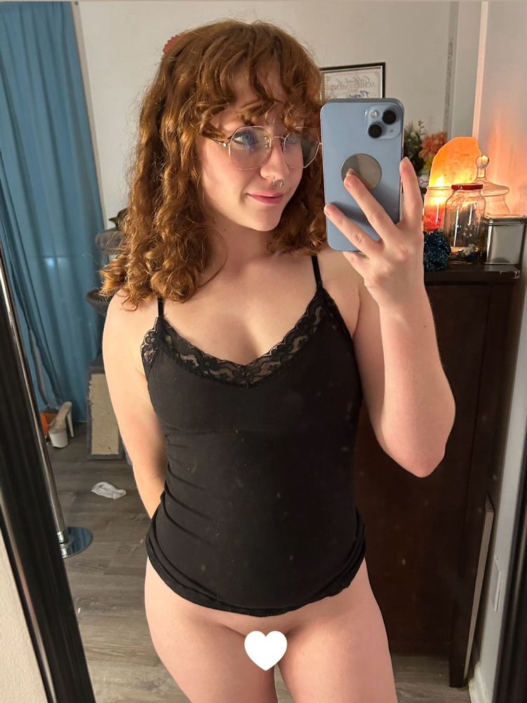 Mirror selfie with a red headed woman, wearing glasses and a black lacy tank top. She has no panties on, and there is a little heart covering her bits

redhead ginger red hair mirror selfie mirrorselfie 🖤🧡 pale