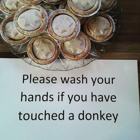 A photo of some mince pies with a notice underneath that says "Please wash your hands if you have touched a donkey."