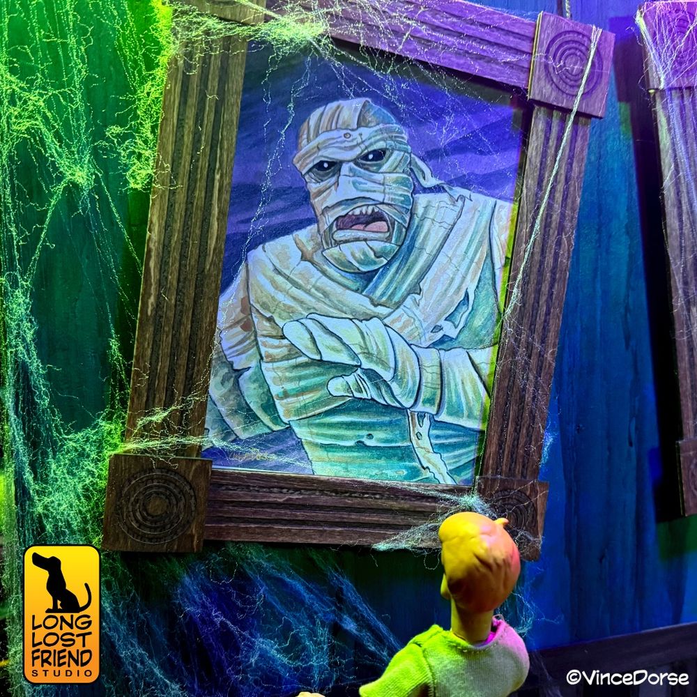 Watercolor portrait of The Mummy from Scooby Doo. Painted by Vince Dorse. An action figure of Shaggy is standing and looking at the portrait. 