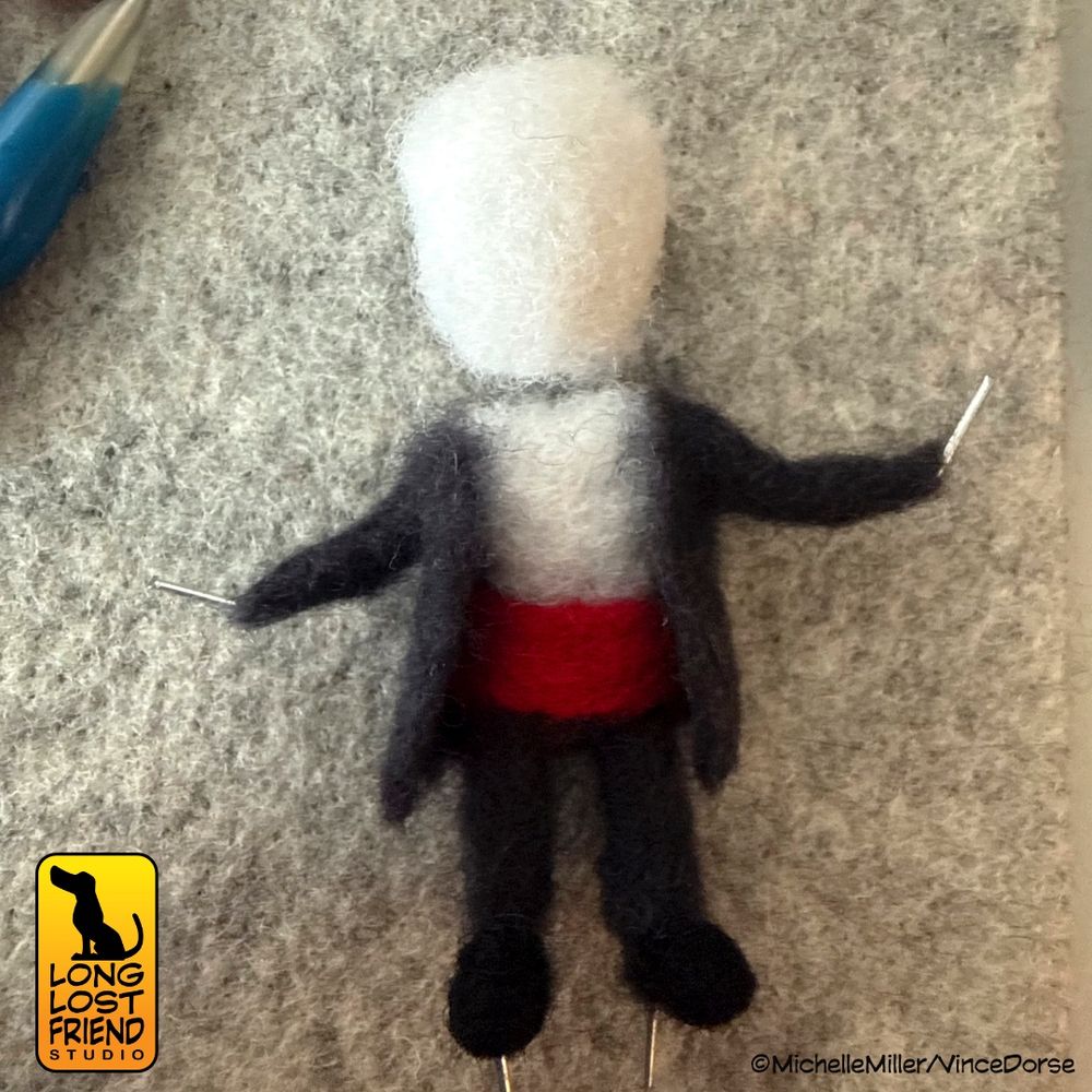 Phantom of the opera needle felted miniature figure in progress. Still no hands or head, but the black tuxedo and red cumber bun are completed.