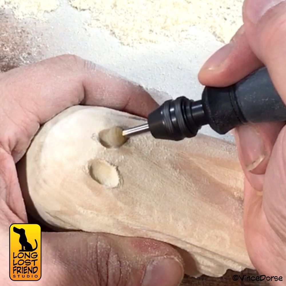 Wood carving of a sheet ghost in process. Using the Dremel and a coarse burr to carve out eye.