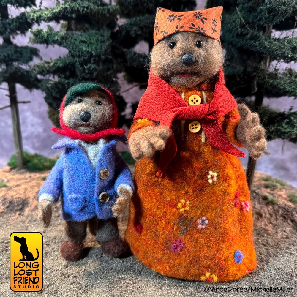 Needle felted Muppet characters by @runredrun.bsky.social
Emmet Otter and Ma, standing in a pine forest diorama