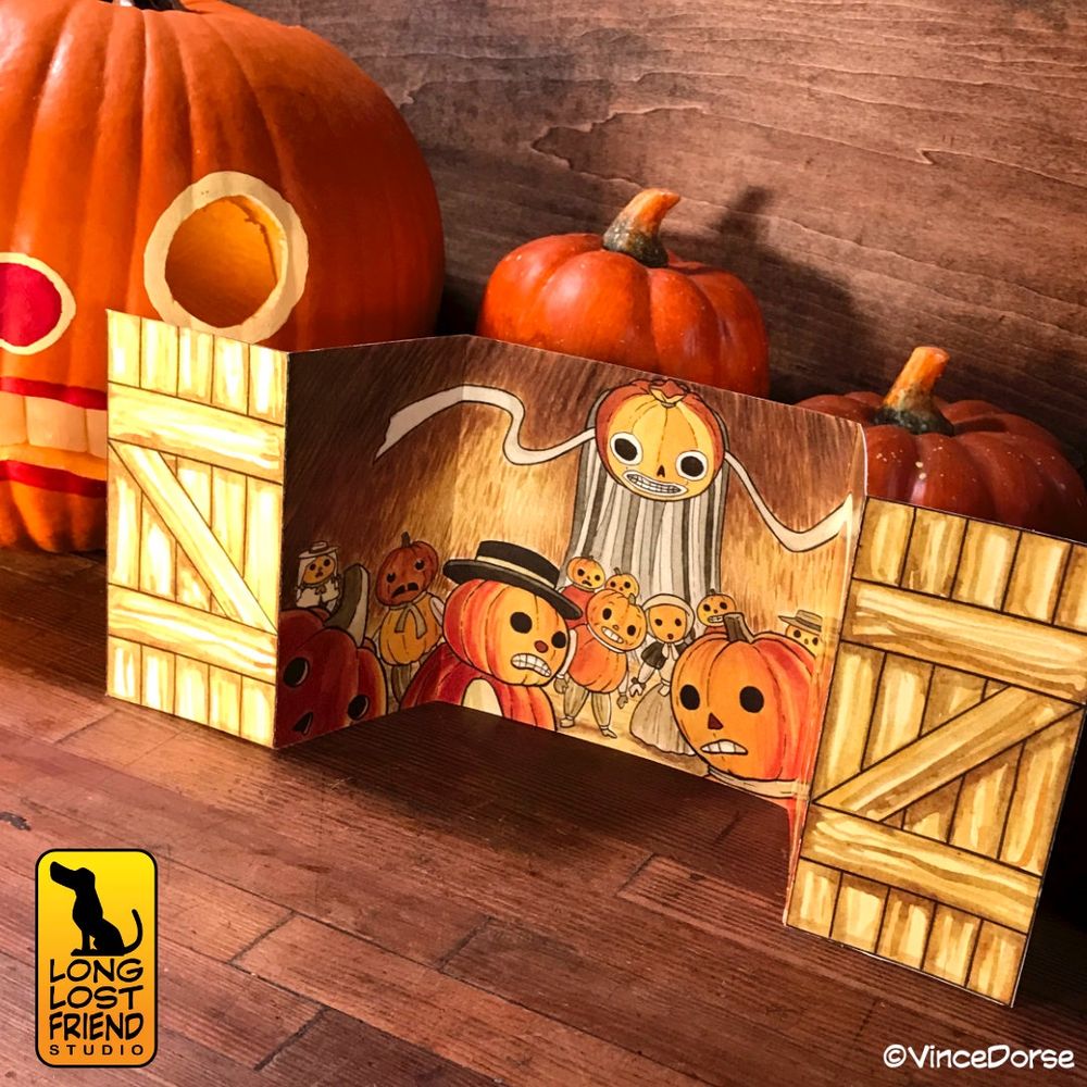 The printed version of the illustration and watercolor piece inspired by Over the Garden Wall. Artwork done by Vince Dorse. The card is displayed in front of pumpkins.