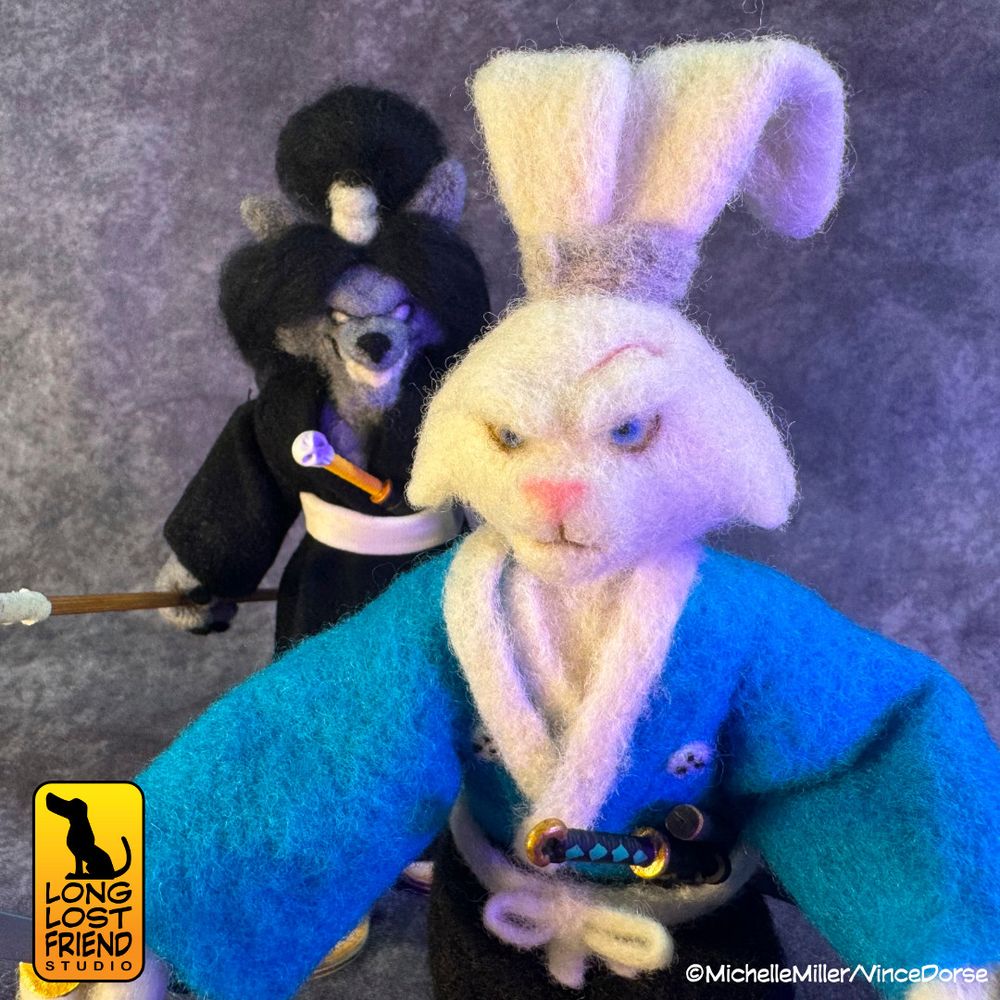 Needle felted Jei figure sneaking up behind the needle felted Usagi figure.