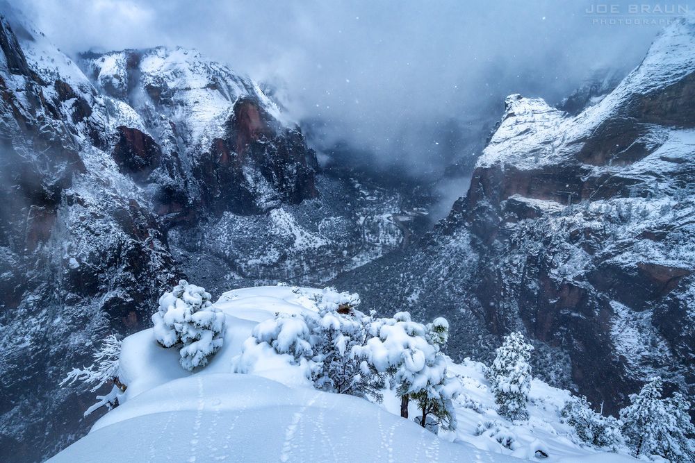 the Angels Landing viewpoint in winter during a big snowstorm