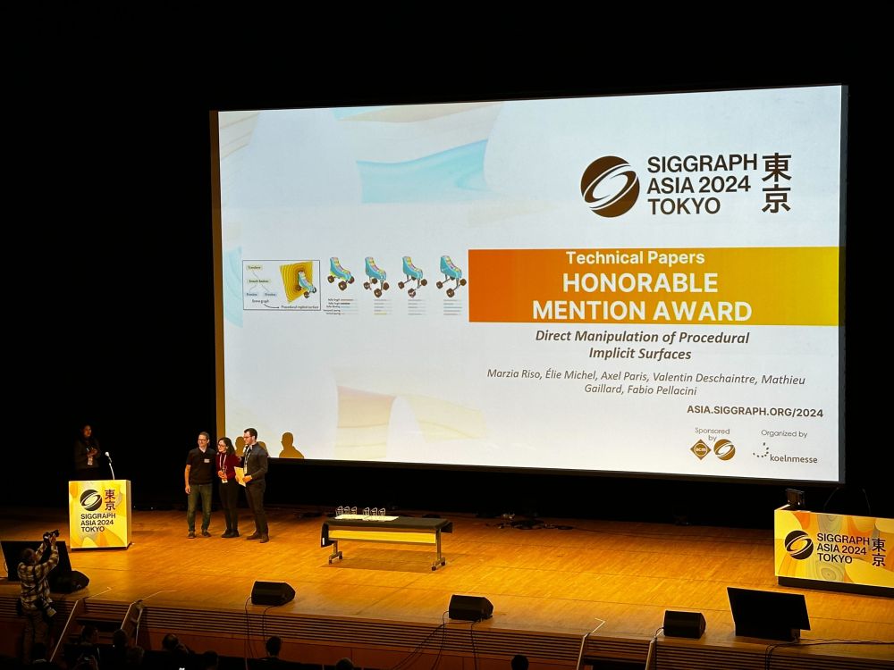 Picture of a stage at SIGGRAPH Asia, where we receive the Honorable Mention Award