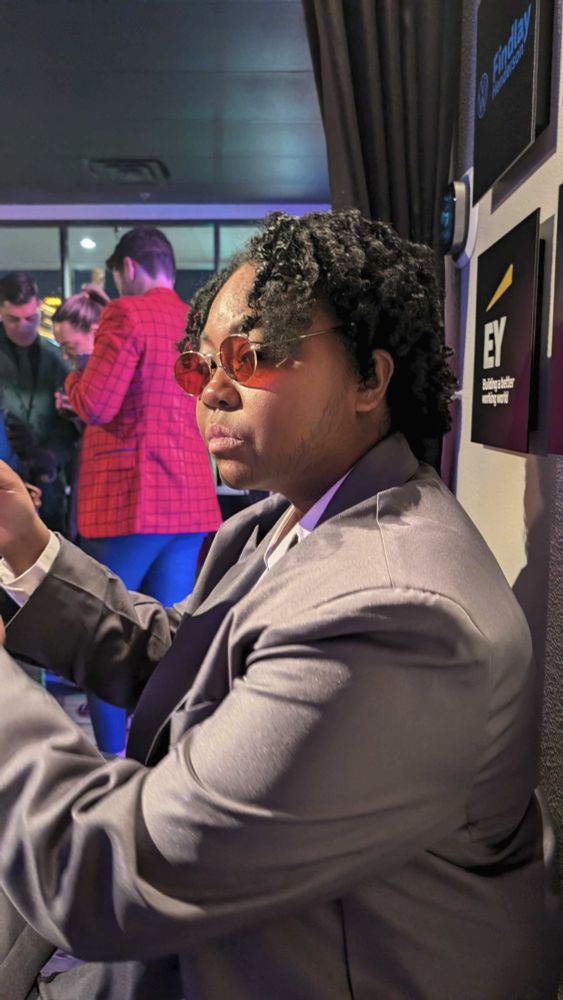 patchouliies dressed as Matthew Murdock from Marvel's Daredevil looking over their shoulder with a small pout on their face.