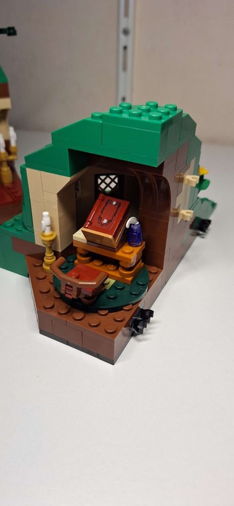Made from Lego: Bilbo's writing corner, his red book on a desk with a quill and a chair.
