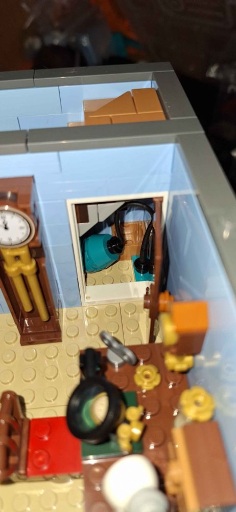 Another angle of the clockmakers home, it shows another grandfather clock and a closet which contains a crate and a vaccum cleaner.