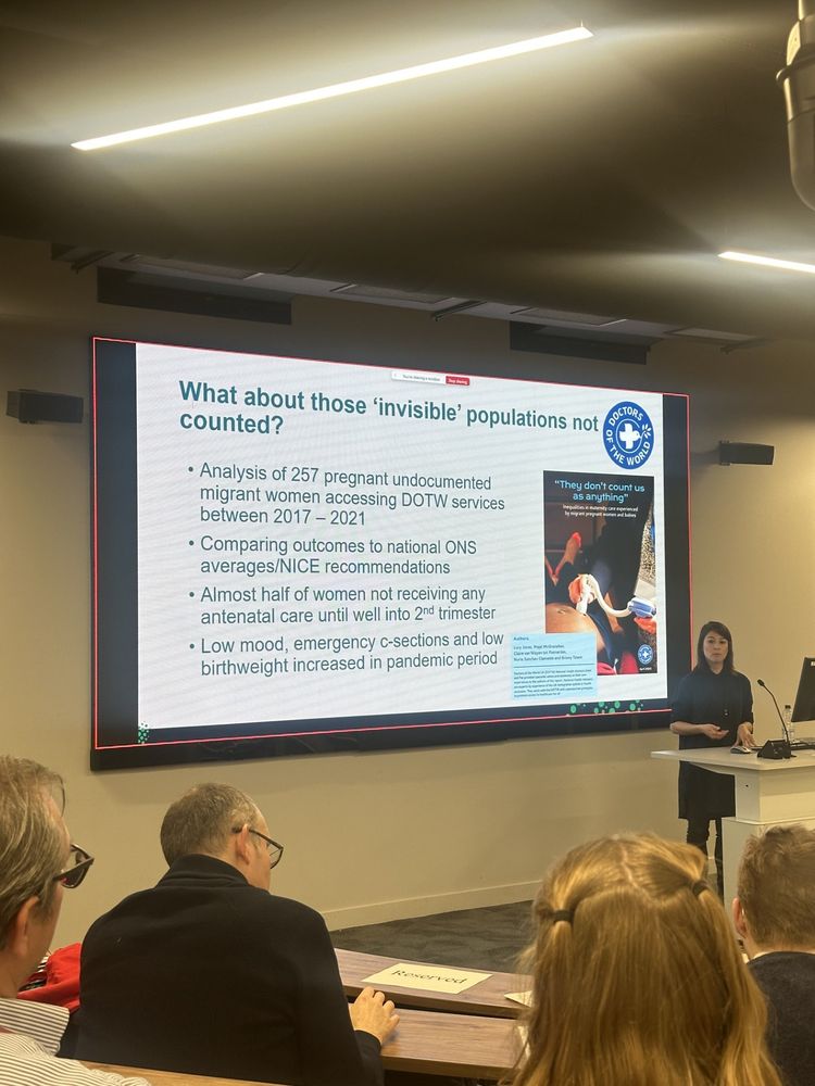 Nuria Sanchez Clemente presents in front of a presentation slide that reads "What about those 'invisible' populations not counted?" and provides a few key statistics on undocumented migrant women accessing DOTW services.