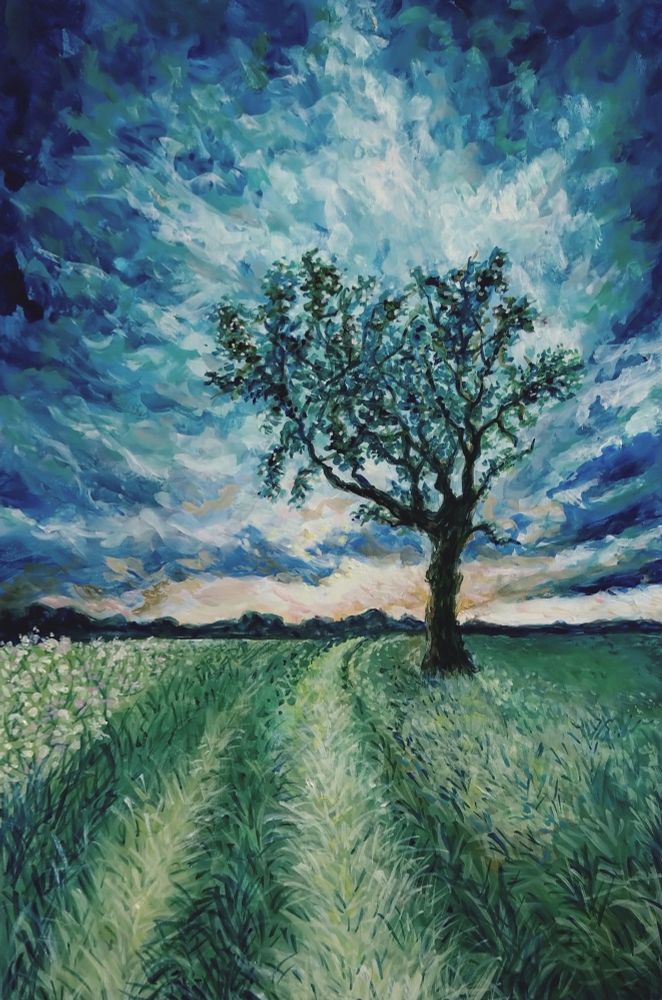 A gouache painting of a solitary tree standing in the middle of a rural landscape under a moody, stormy sky. The composition features shades of indigo, turquoise, and pale orange towards the horizon, where the setting sun is hidden behind clouds. The ground is covered in green grass, with some areas in the center flattened by tire track marks. On the left side, there's a small field of flowers.