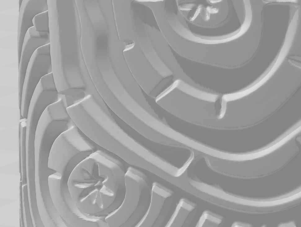 A close-up view of a 3D model of a texture roller with a tree ring design. The edges of the raised impression surface are lightly angled or softened, not 90-degree sharp edges. The imprints in the roller also have a soft or beveled edge to them.