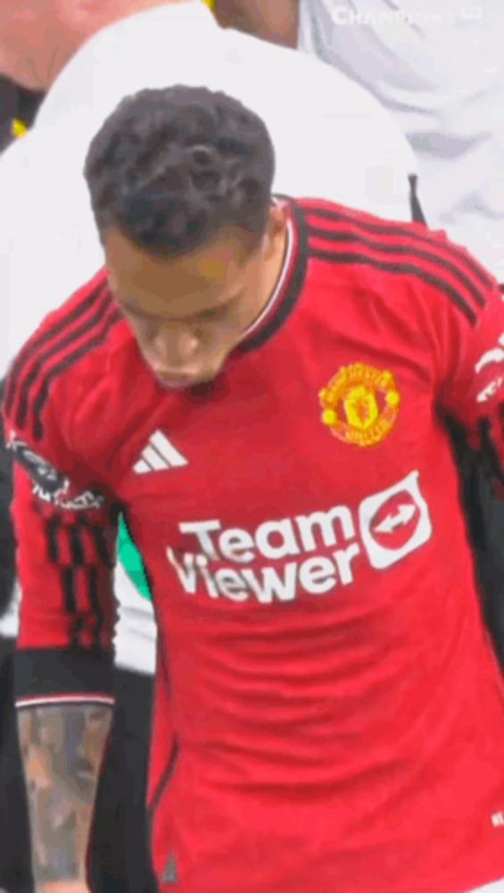 a soccer player is wearing a red jersey with team viewer on it