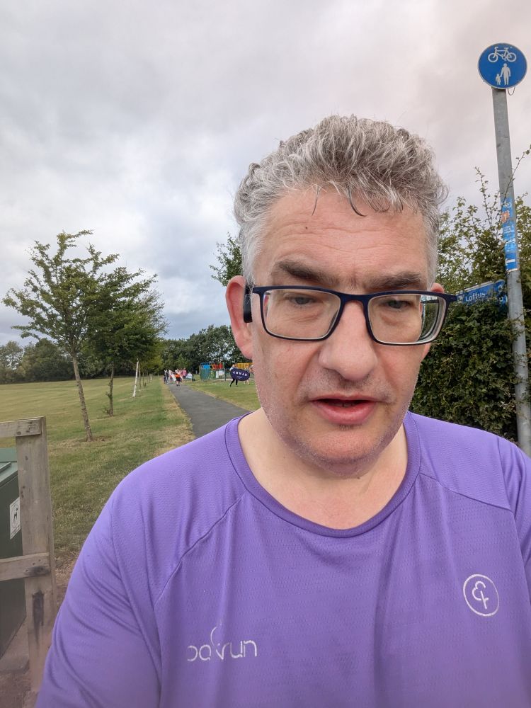 The post author, post run, in his Parkrun v25 running top 