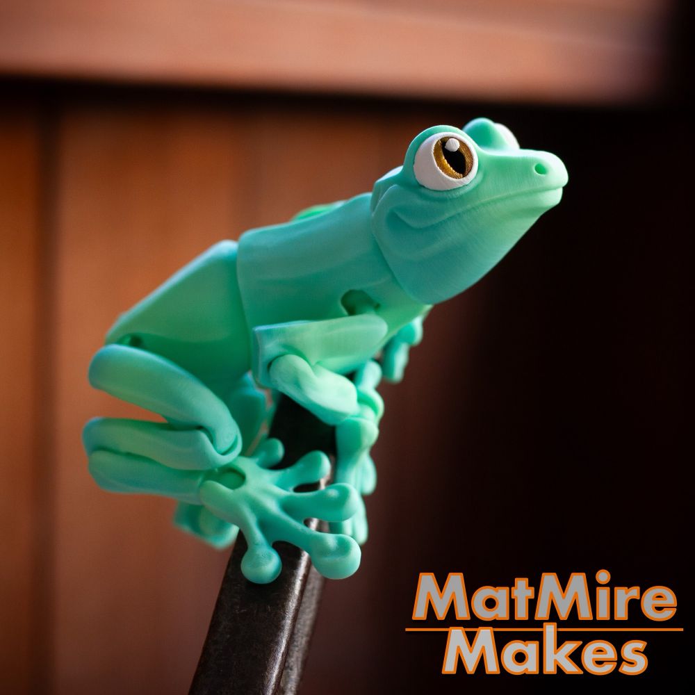 Mint green 3D printed frog. Magnetically holding on to a metal handle.