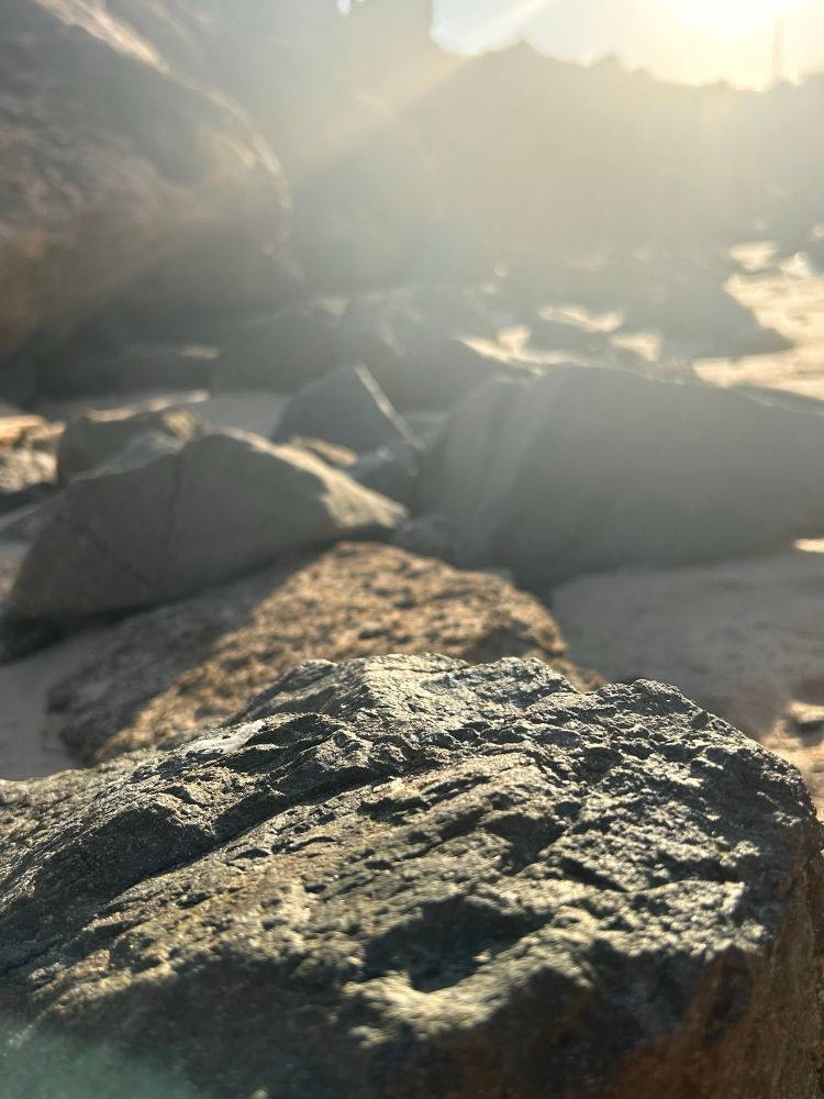 The sun shining down on some rocks. 