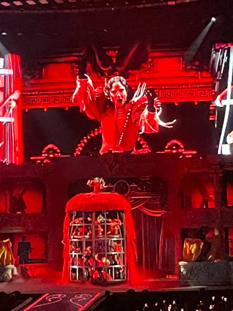 Gaga at the top of the giant red dress cage thingy 