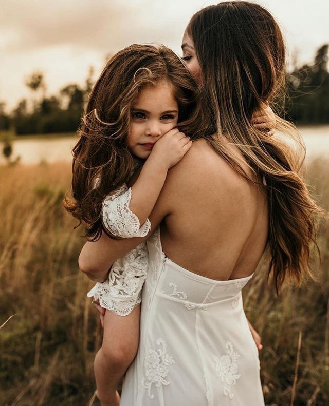 Mother holding her young daughter in her arms