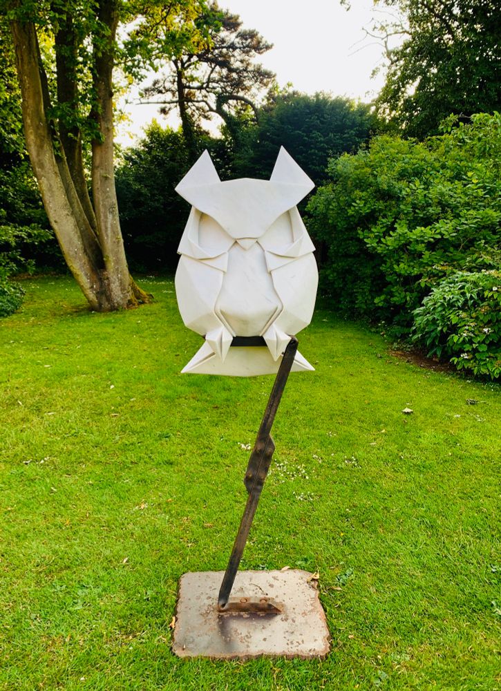 Owl la la! by Regis Chaperon, a stone sculpture of a perching owl in the form of origami.